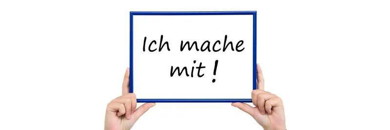 Hände wie sie ein Schild hochhalten mit der Aufschrift "Ich mache mit!"