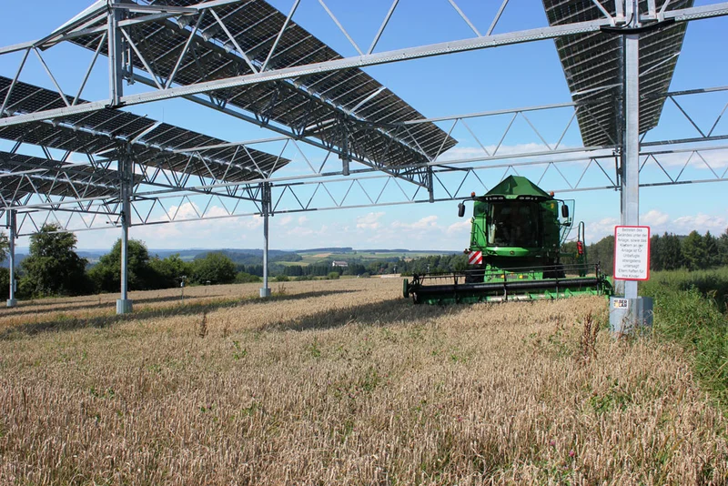 Mähdrescher unter Solarmodulen. Klick führt zu Großansicht in neuem Fenster.