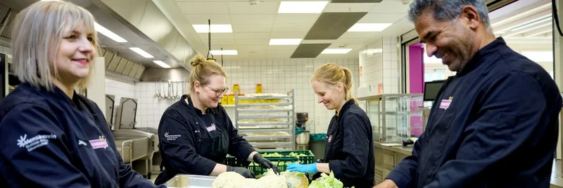 Vier Personen in der Küche.